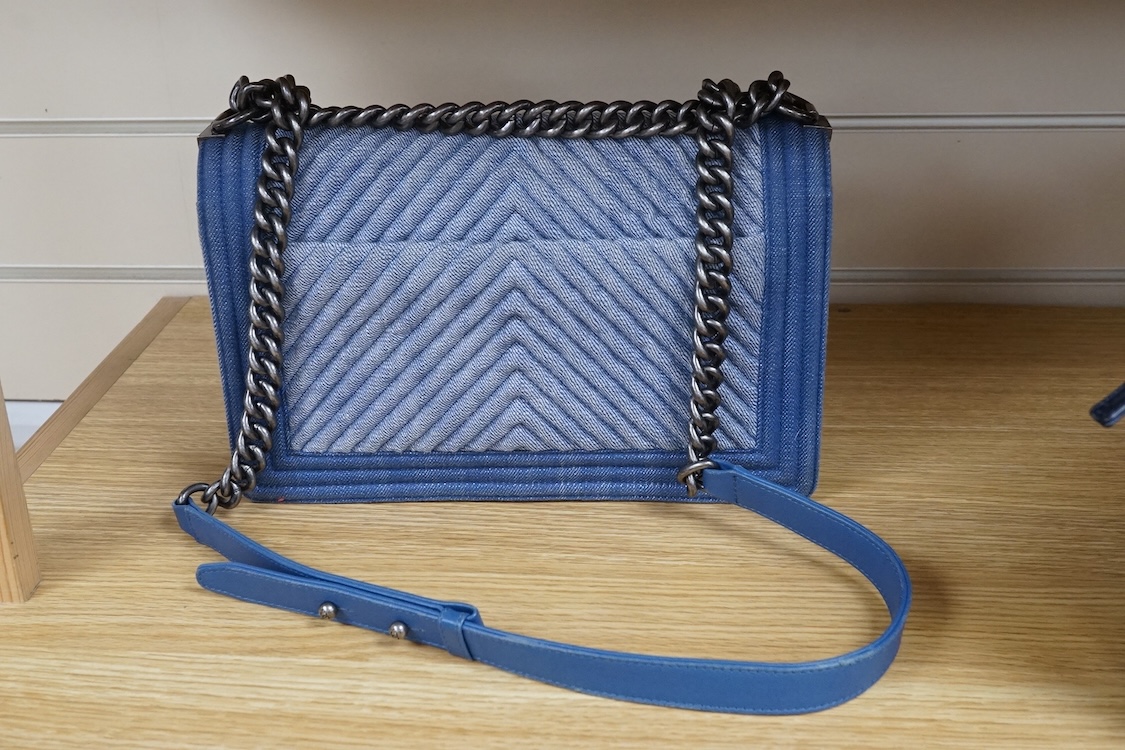 A Chanel denim cheveron flap shoulder bag with silver hardware, date code 20845697, 28cm wide